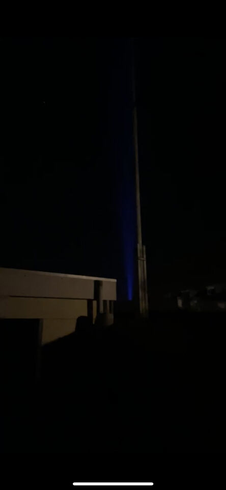 Blauw baken van licht, bewegend over huizen. foto