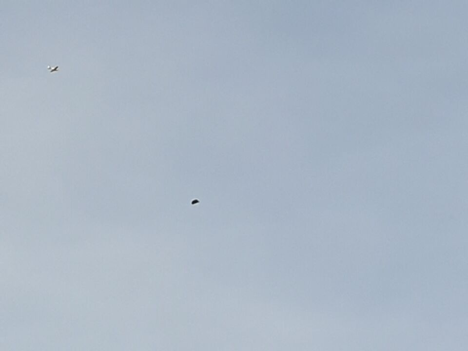 Zwart vliegend driehoekig object foto