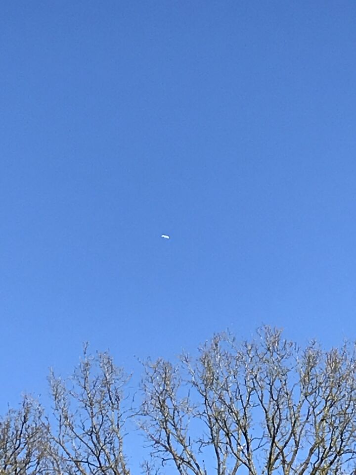 Langwerpig horizontaal 5 tot 6 x langer dan hoog, wit lichtend, vliegende ‘bus’ foto