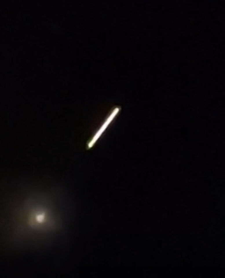 Een gloeiende bol met daarop volgend een lijn van licht foto